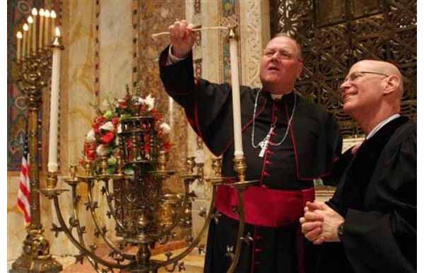 The Archbishop of New York lights a candle on menorah